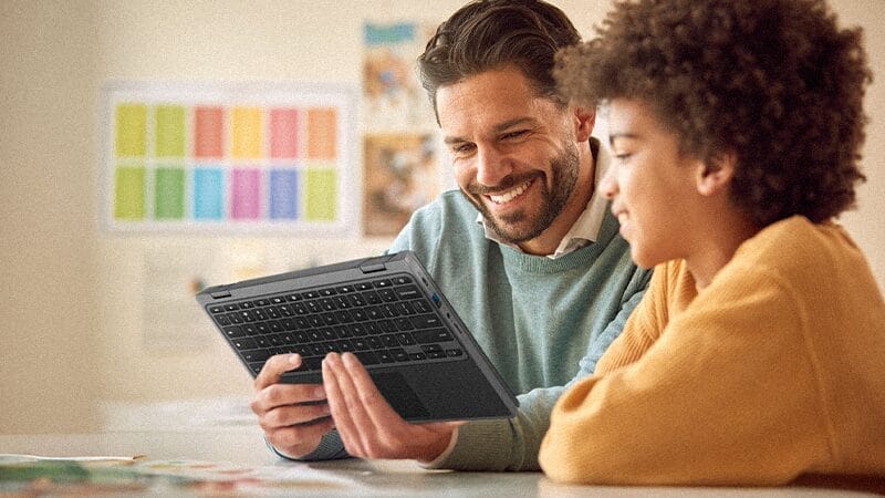 Computational thinking acer for education teacher smiling in front of a flipped-tablet-style acer chromebook with a smiling student by his side